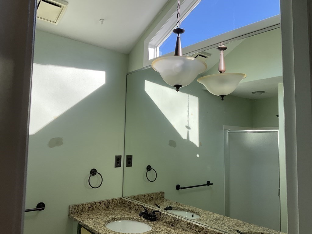 992 Pleasant Street Framingham, MA 01701 - Photo 14 of 29 a bathroom with a granite countertop sink a mirror and toilet