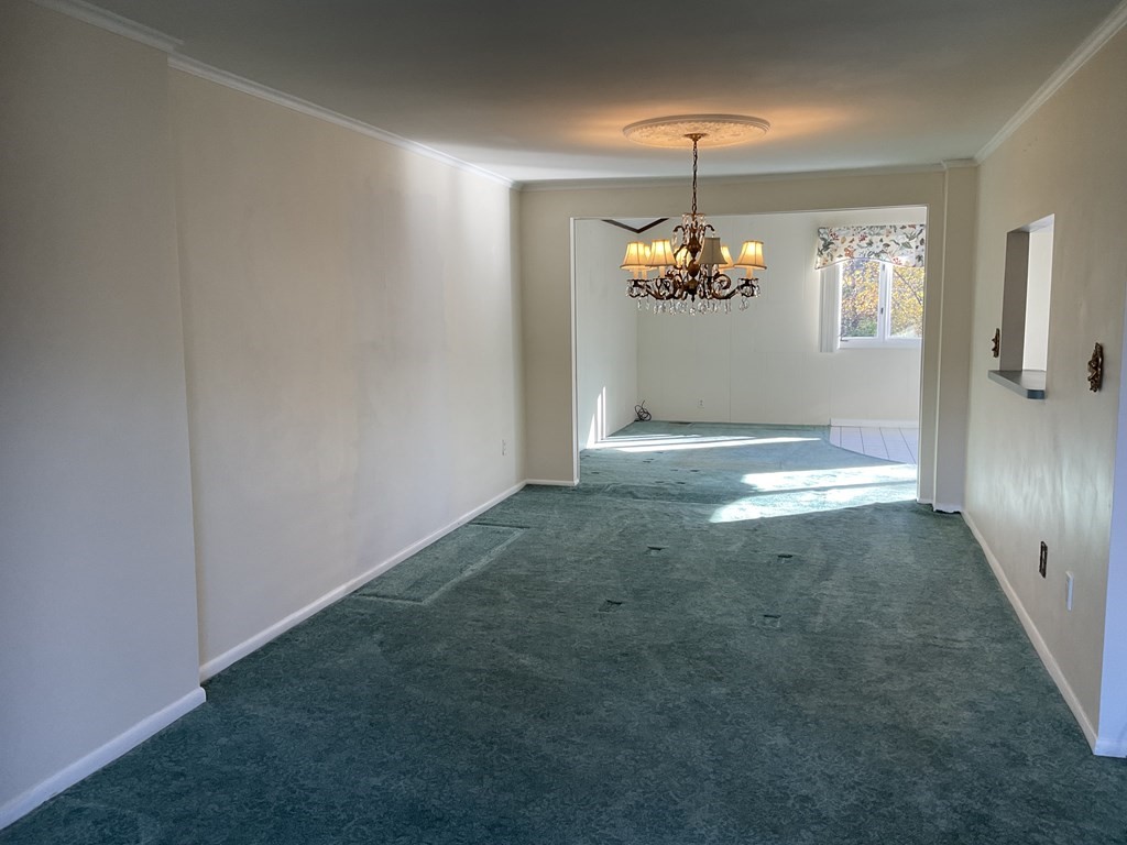 992 Pleasant Street Framingham, MA 01701 - Photo 5 of 29 a view of a livingroom with a chandelier fan and windows