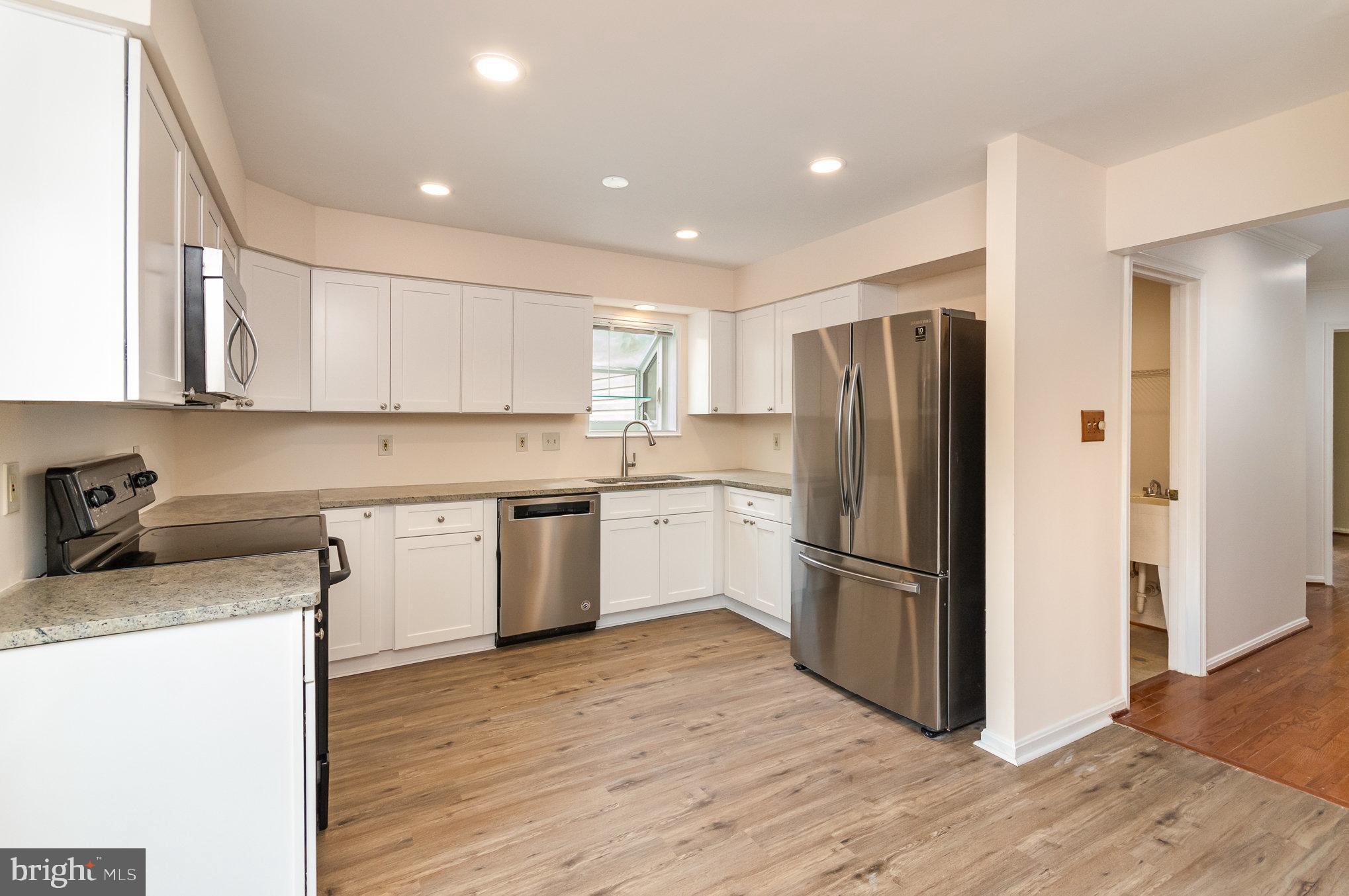2968 Emerald Chase Drive Herndon, VA 20171 - Photo 13 of 29 a kitchen with a refrigerator sink and cabinets