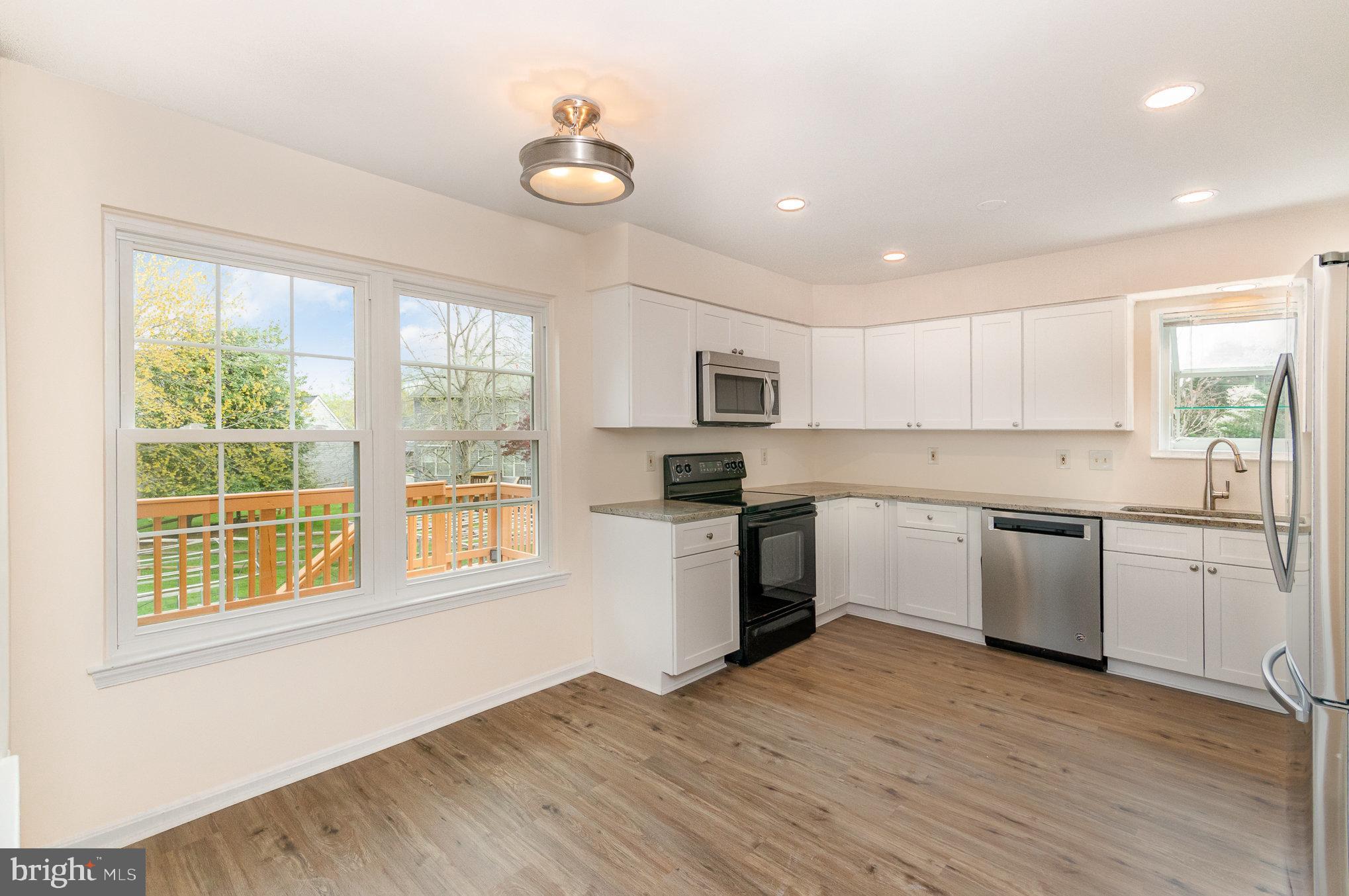 2968 Emerald Chase Drive Herndon, VA 20171 - Photo 14 of 29 a kitchen with granite countertop a stove top oven sink and cabinets