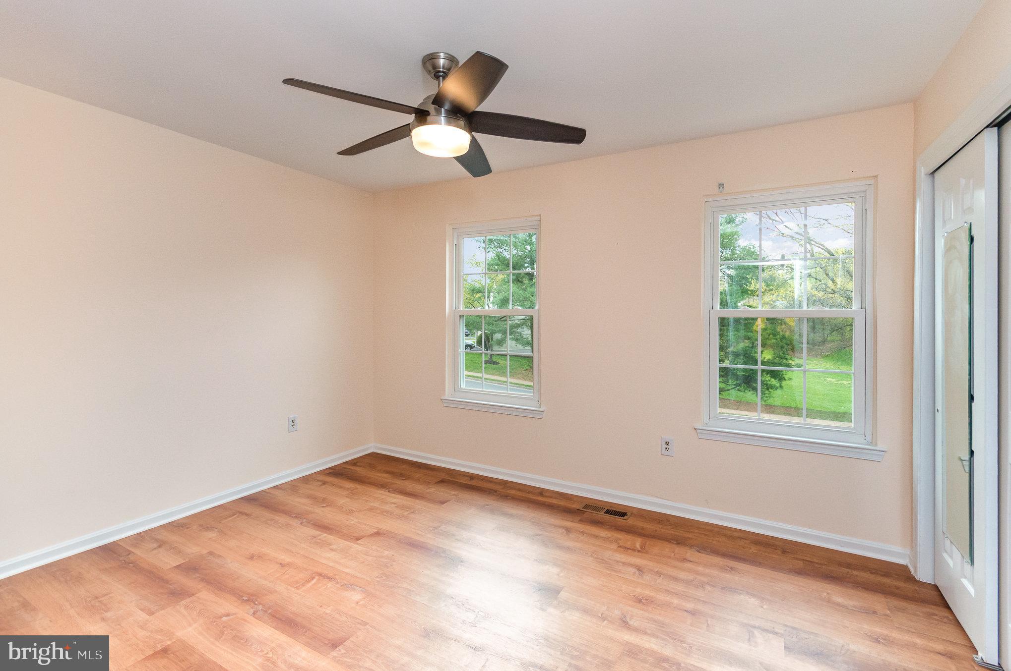 2968 Emerald Chase Drive Herndon, VA 20171 - Photo 17 of 29 an empty room with wooden floor fan and windows