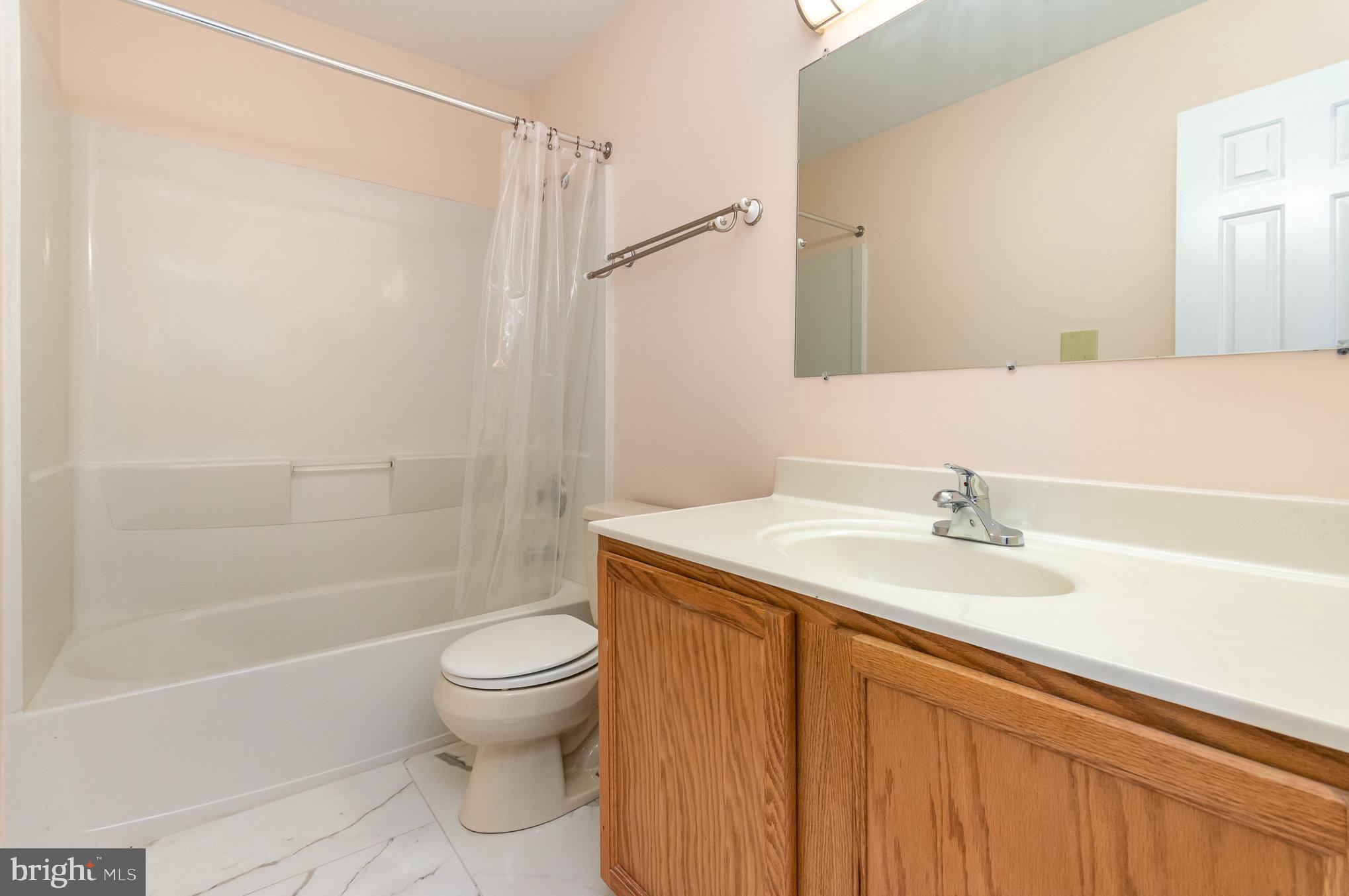 2968 Emerald Chase Drive Herndon, VA 20171 - Photo 18 of 29 a bathroom with a sink a toilet and shower