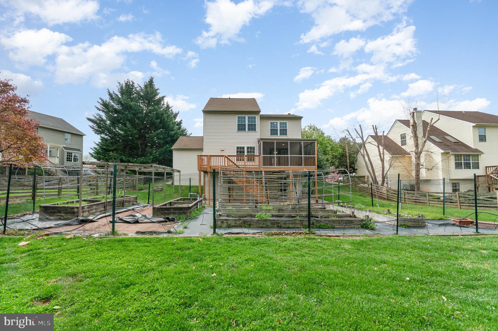 2968 Emerald Chase Drive Herndon, VA 20171 - Photo 8 of 29 a view of a house with a backyard and a garden
