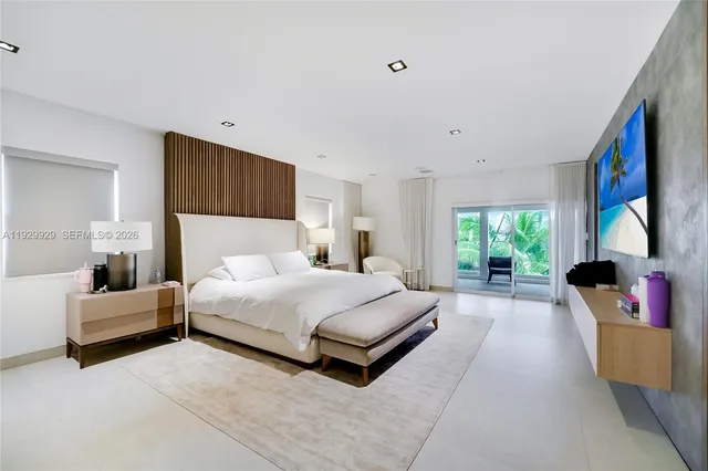 a bedroom with a bed and a night stand