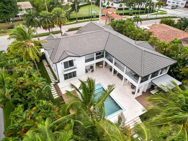 an aerial view of a house with a yard and potted plants