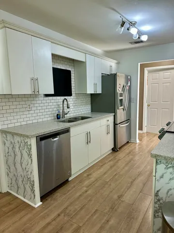 a kitchen with a sink stove and refrigerator