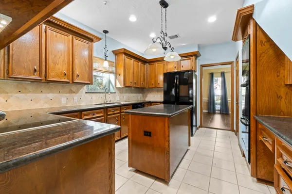 a kitchen that has a lot of cabinets in it and a window