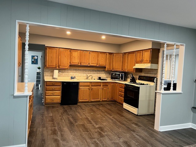 17 Wildwood Road Elk Grove Village, IL 60007 - Photo 3 of 11 a kitchen with stainless steel appliances kitchen island granite countertop a stove a sink and a microwave