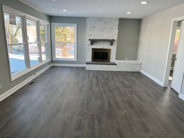 17 Wildwood Road Elk Grove Village, IL 60007 - Photo 4 of 11 an empty room with wooden floor fireplace and windows