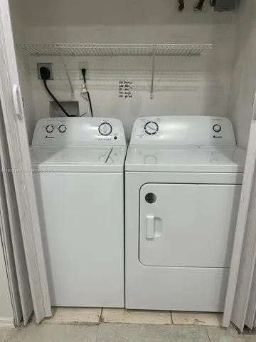 a street sign that is on a brick wall