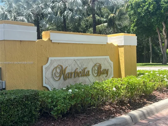 a view of a yard with large trees and wooden fence