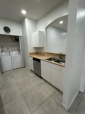 a kitchen with stainless steel appliances granite countertop a sink and a stove