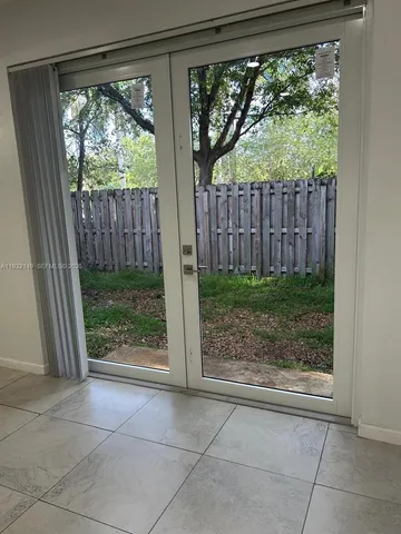 a view of an empty room with a ceiling fan