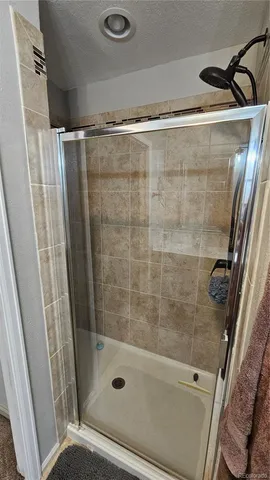 a bathroom with a shower and a sink