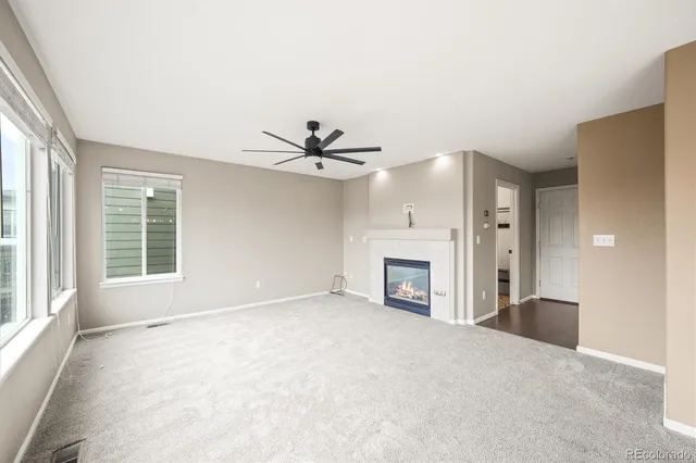 a large kitchen with a large counter top stainless steel appliances and cabinets