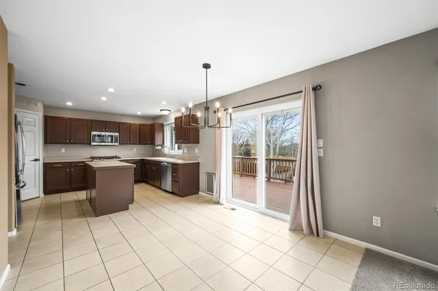 a kitchen with a sink a counter top space stainless steel appliances and cabinets