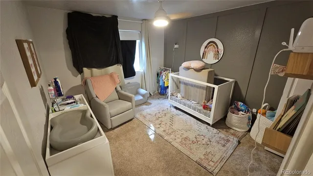 a living room with furniture a rug a fireplace and a flat screen tv