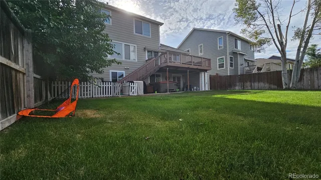 a view of a house with a yard and sitting area