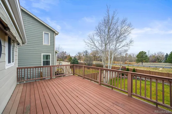 a view of balcony with wooden floor and fence