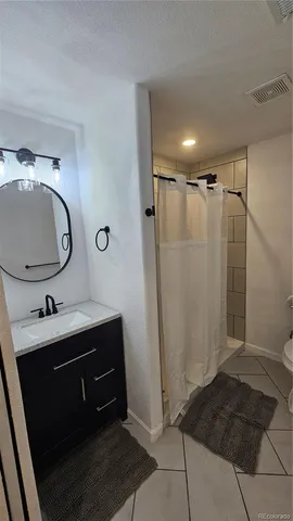 a bathroom with a sink a mirror and shower