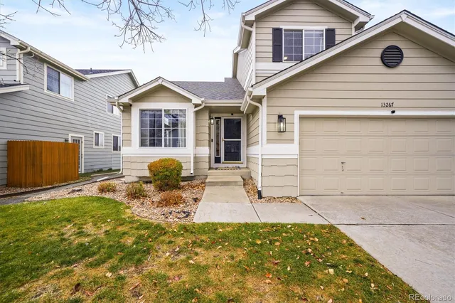a front view of a house with yard and porch