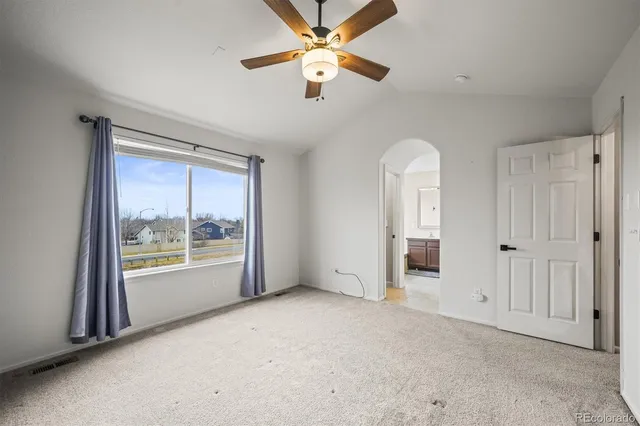 an empty room with windows and closet