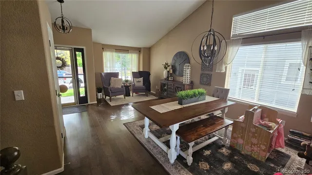 a living room with furniture a window and wooden floor