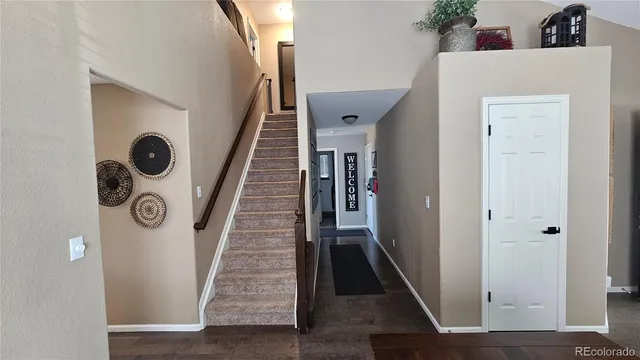 a view of entryway and hall with wooden floor
