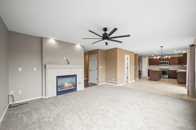 a view of an empty room with a fireplace and a window
