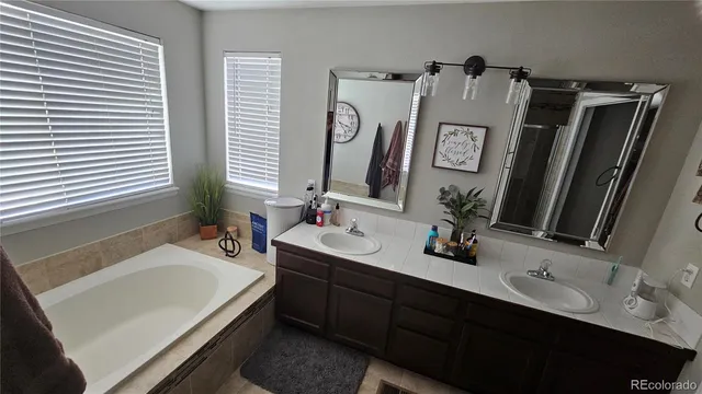 a bathroom with a double vanity sink and mirror