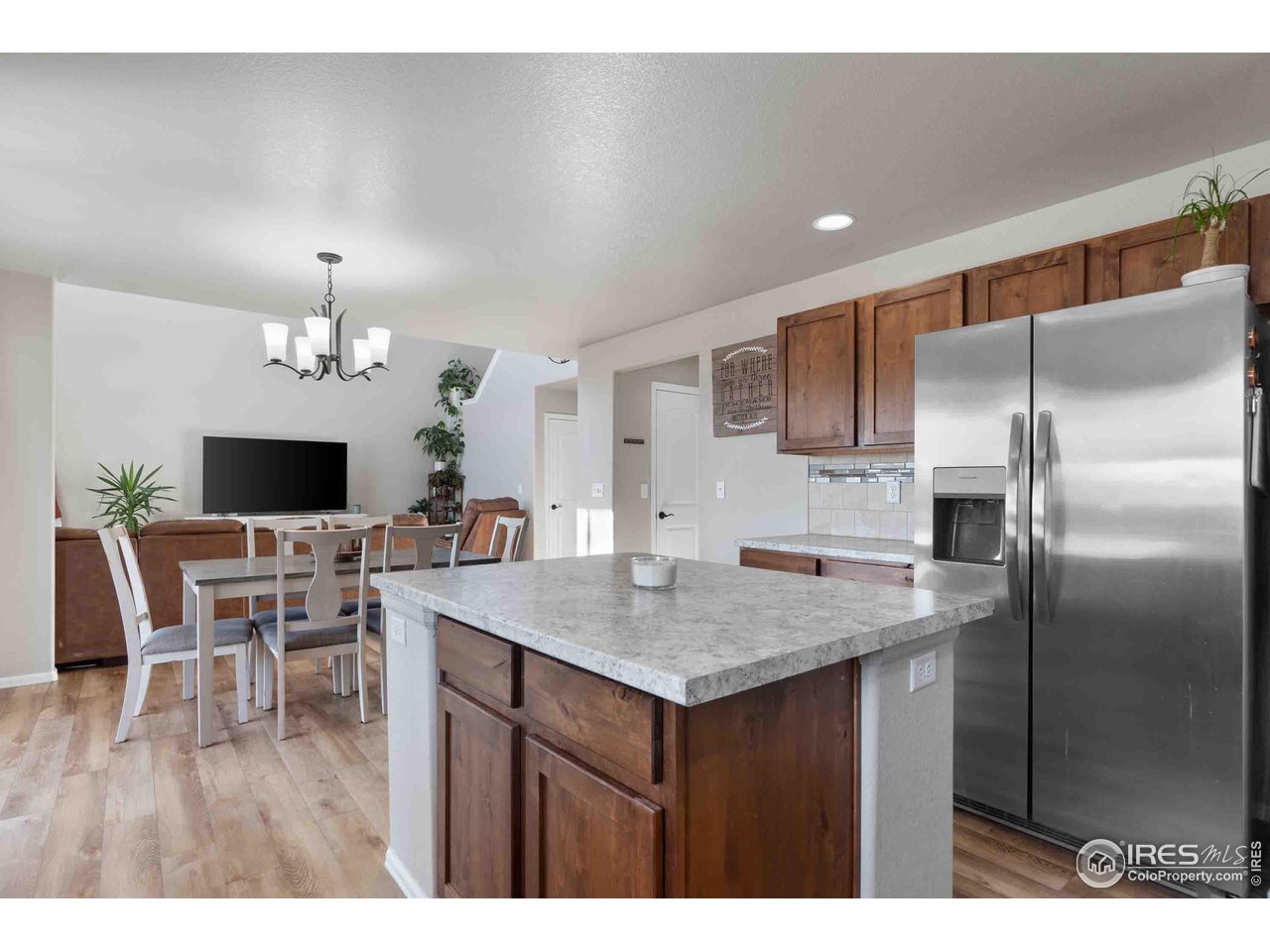 522 Lowland Street Severance, CO 80550 - Photo 30 of 30 a kitchen with a table and refrigerator