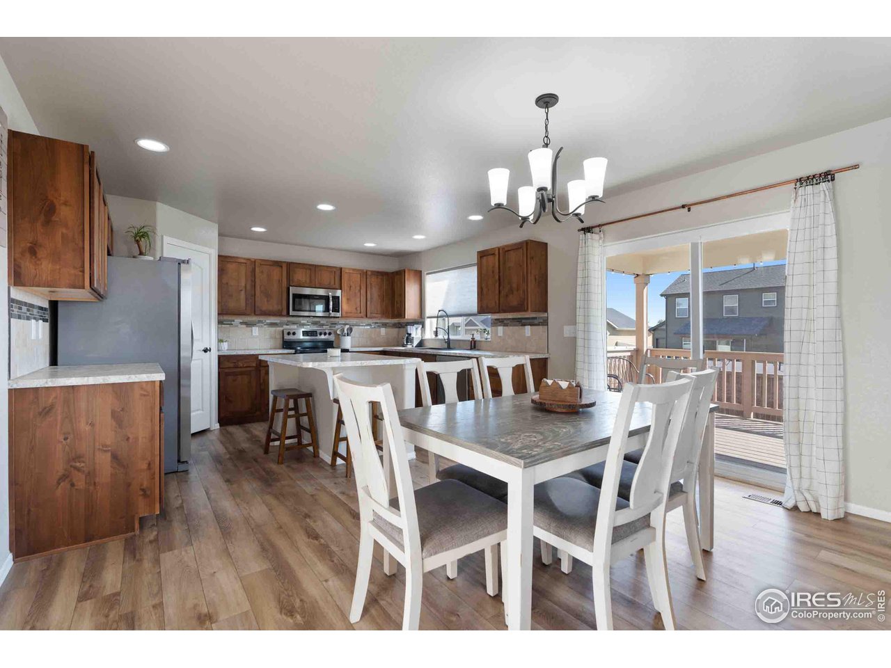 522 Lowland Street Severance, CO 80550 - Photo 6 of 30 a view of a dining room with furniture and wooden floor