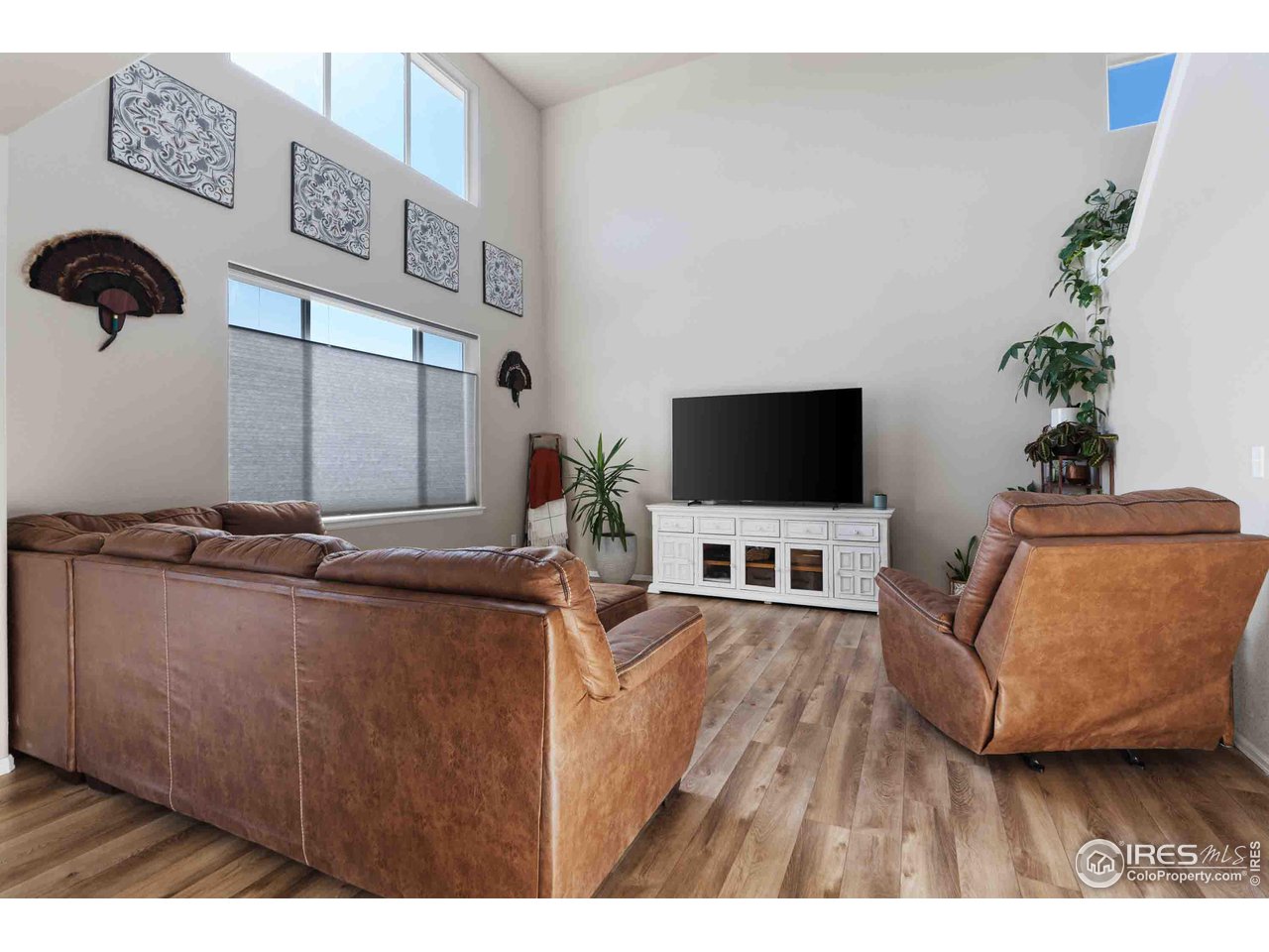 522 Lowland Street Severance, CO 80550 - Photo 9 of 30 a living room with furniture and a flat screen tv