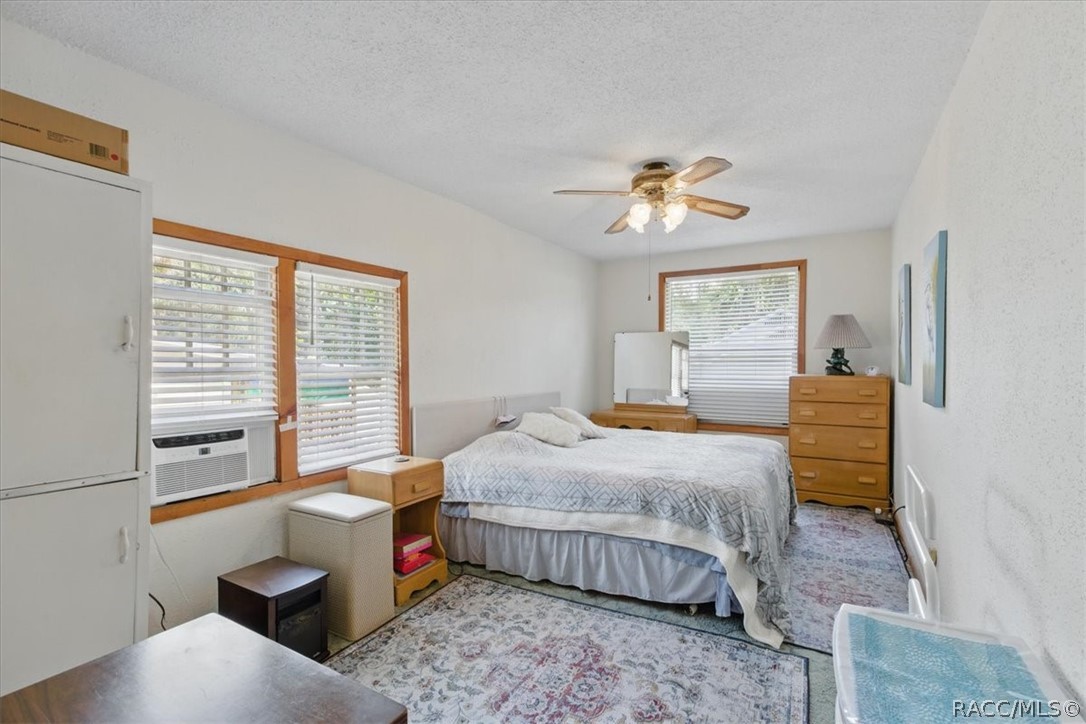 6 62nd Street Yankeetown, FL 34498 - Photo 12 of 55 a bedroom with a bed and a chandelier