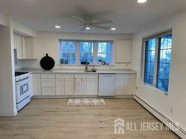 a kitchen with stainless steel appliances kitchen island granite countertop a sink and cabinets