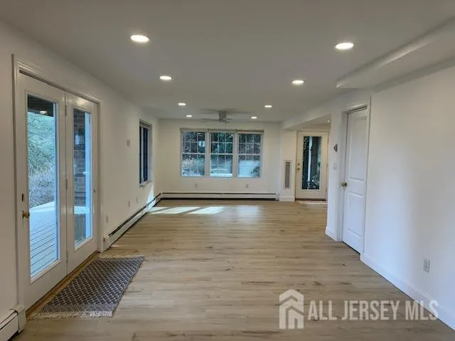 a view of an empty room with wooden floor