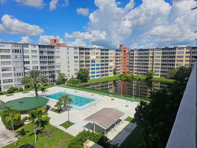 a view of a balcony with a floor to ceiling window next to a yard