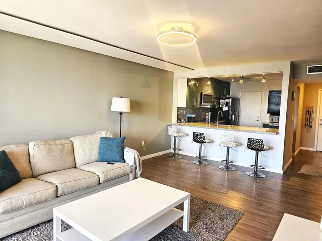a view of living room with furniture and a flat screen tv