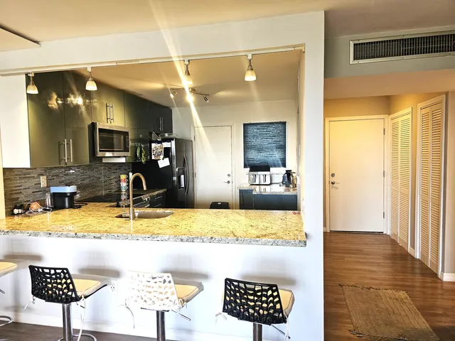 a view of a room that has a bed in it