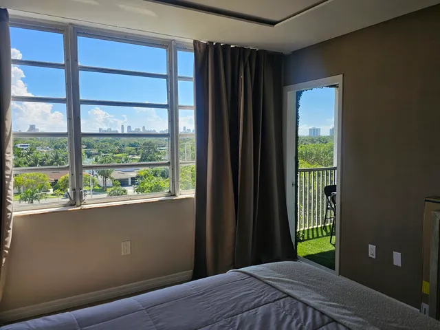 a dining room with furniture and a potted plant