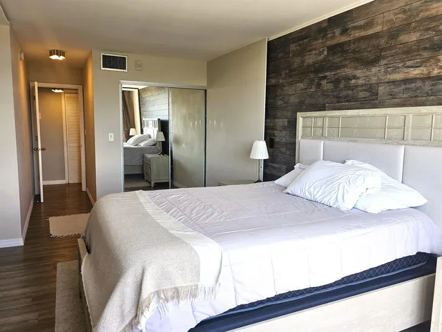 a bedroom with a bed and a mirror