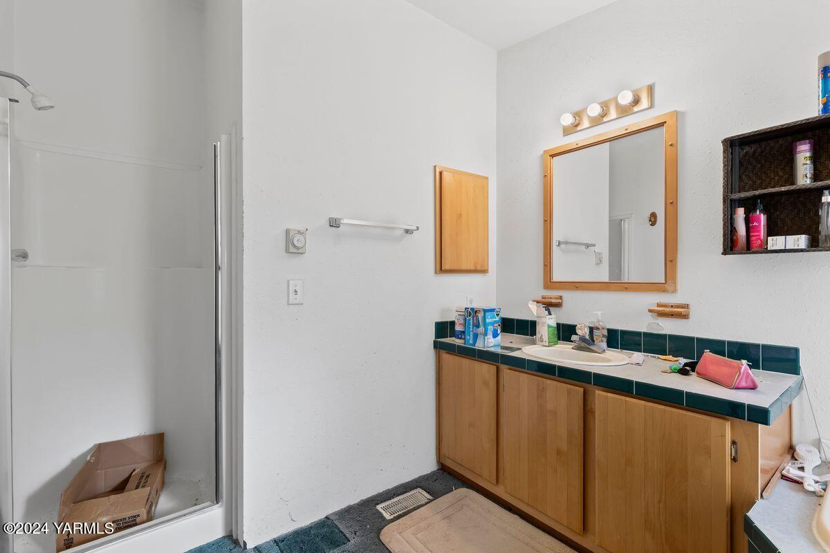 3780 Harrah Road Harrah, WA 98933 - Photo 12 of 26 a bathroom with a sink and a mirror