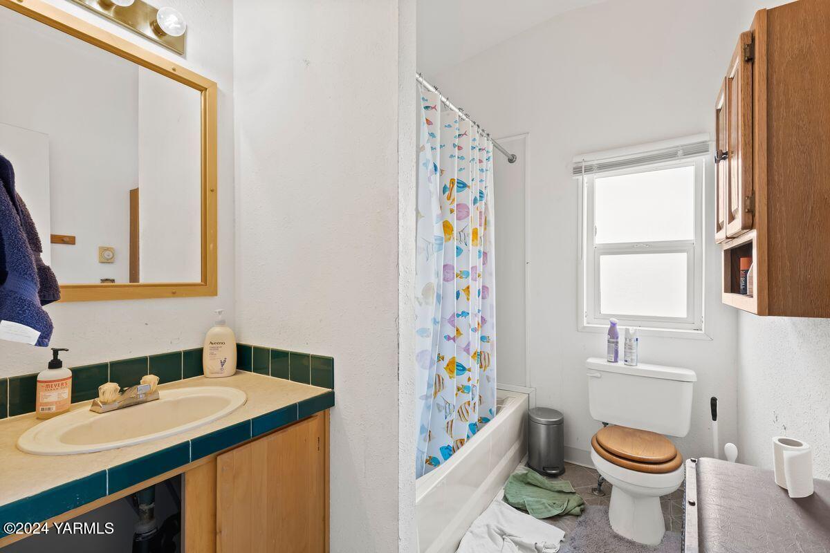 3780 Harrah Road Harrah, WA 98933 - Photo 17 of 26 a bathroom with a sink toilet and window