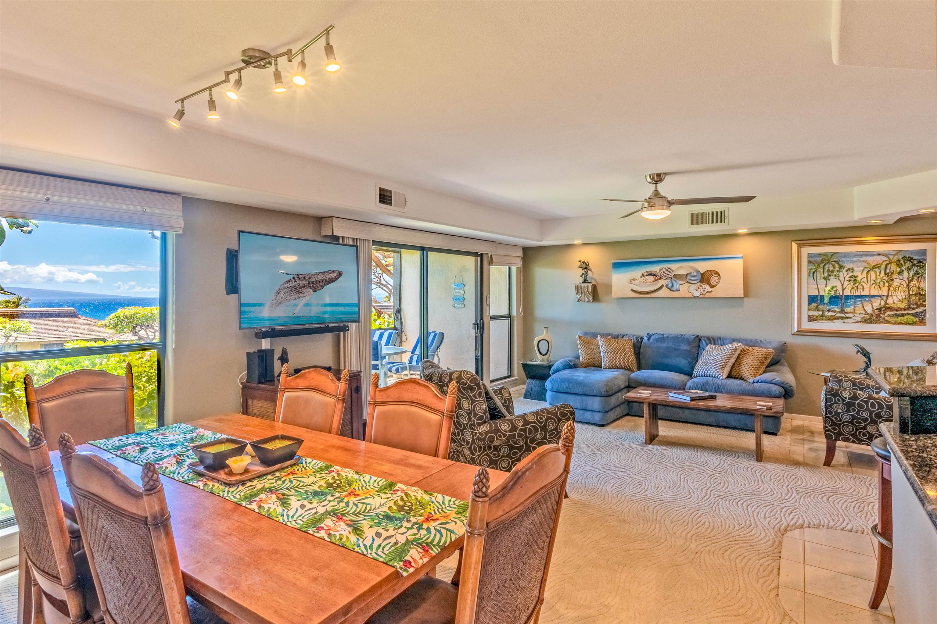 150 Puukolii Road, Unit 18 Lahaina, HI 96761 - Photo 3 of 49 a living room with furniture a flat screen tv and a table