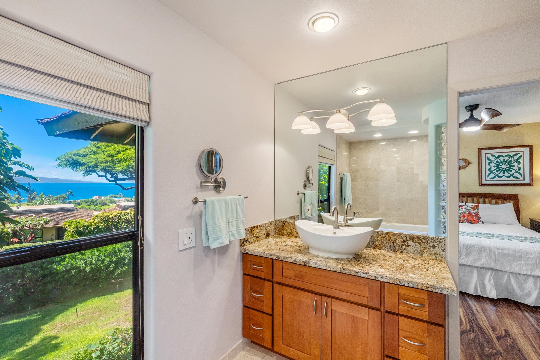 150 Puukolii Road, Unit 18 Lahaina, HI 96761 - Photo 31 of 49 a bathroom with a granite countertop sink and a mirror