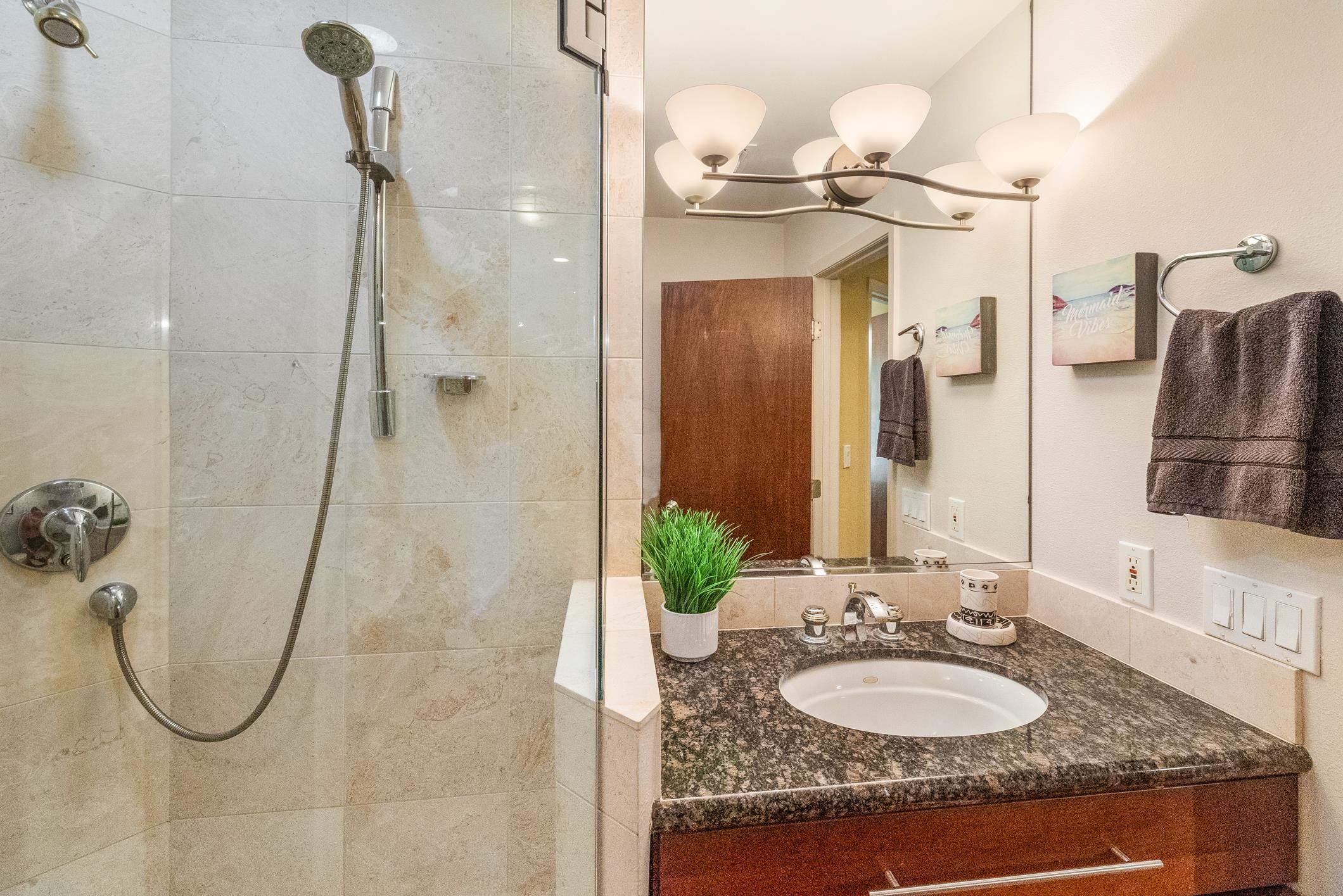 150 Puukolii Road, Unit 18 Lahaina, HI 96761 - Photo 38 of 49 a bathroom with a granite countertop sink and a mirror