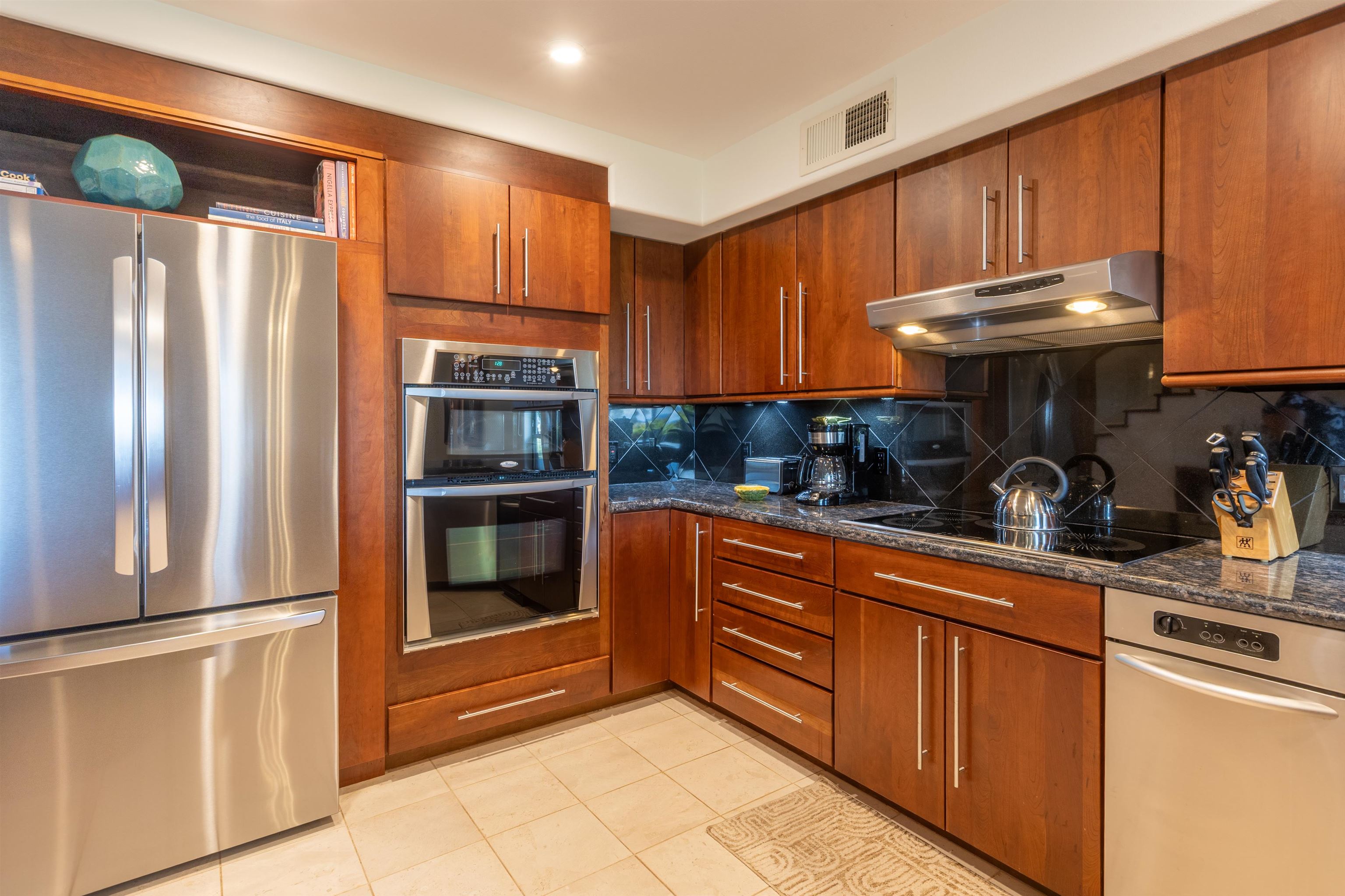 150 Puukolii Road, Unit 18 Lahaina, HI 96761 - Photo 7 of 49 a kitchen with stainless steel appliances granite countertop a refrigerator and a stove top oven