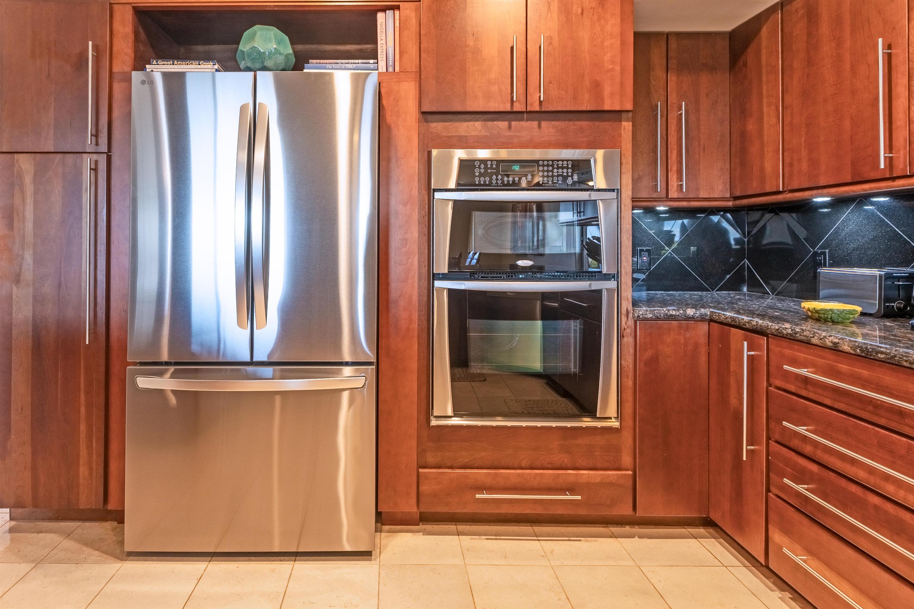 150 Puukolii Road, Unit 18 Lahaina, HI 96761 - Photo 9 of 49 a kitchen with stainless steel appliances granite countertop a refrigerator and a stove top oven
