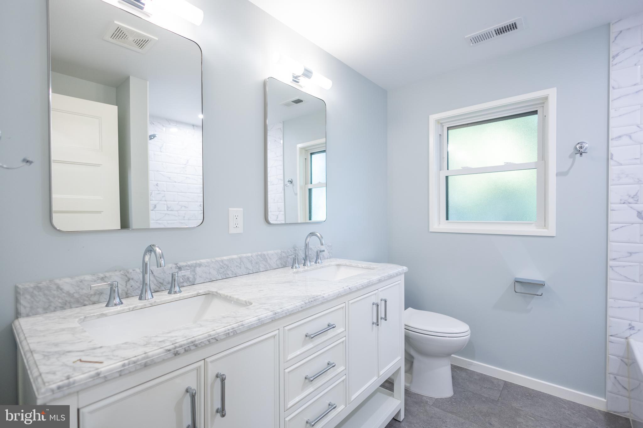 414 Venton Road Edgewater, MD 21037 - Photo 14 of 25 a bathroom with a granite countertop toilet sink and mirror