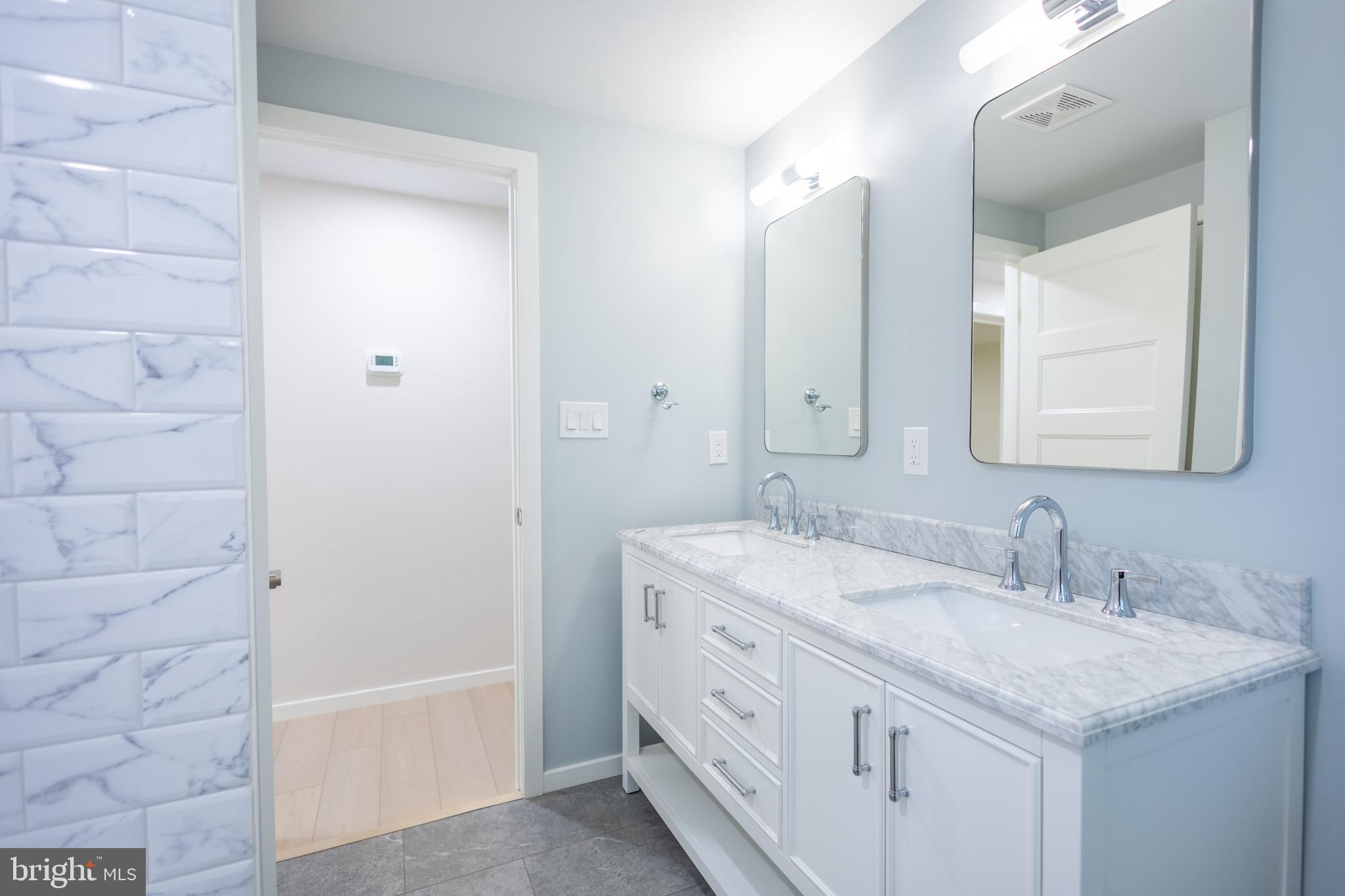 414 Venton Road Edgewater, MD 21037 - Photo 15 of 25 a bathroom with a granite countertop sink a mirror and a bathtub